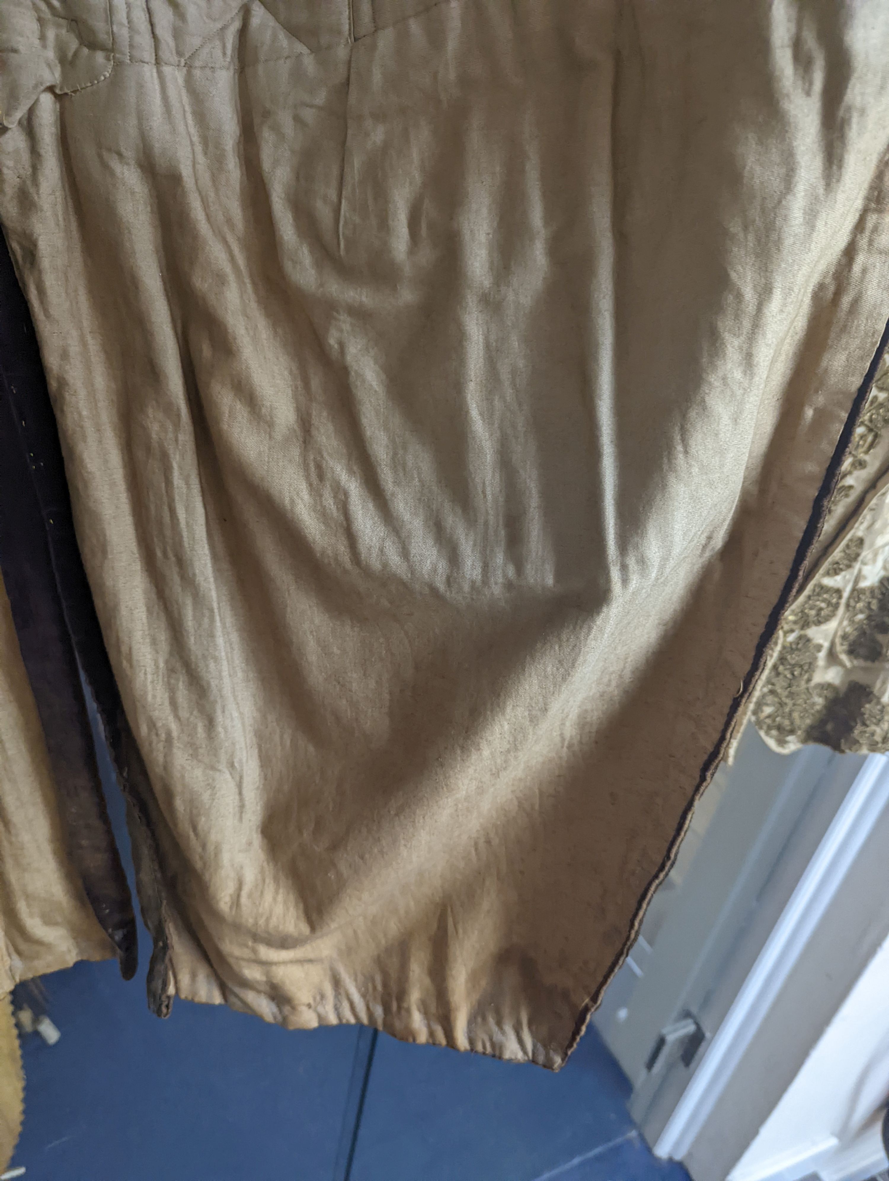 A Georgian gents cream damask waistcoat, a similar waistcoat with beading applied later and a velvet and gold braided tailcoat